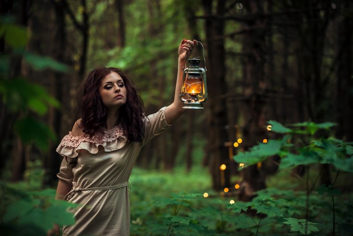 Woman with Kerosene Lamp in Forest