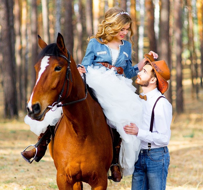 Couple with horse in forest