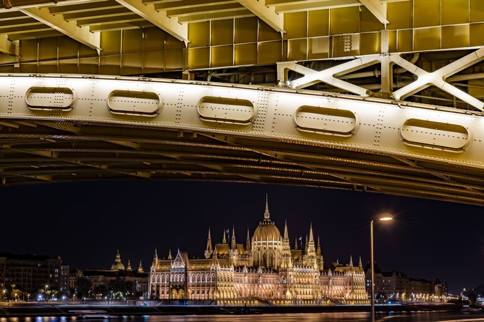 Budapest Parliament Building at Night Under a Bridge