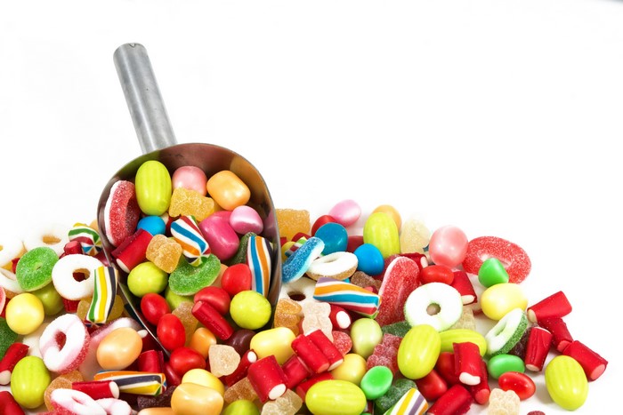 Scoop of colorful candies and sweets