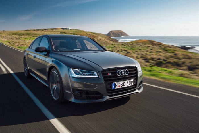 Audi S8 Plus driving on a coastal road