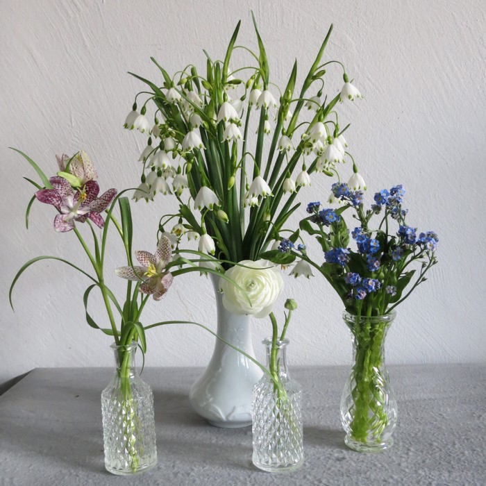 Four flower arrangements in vases