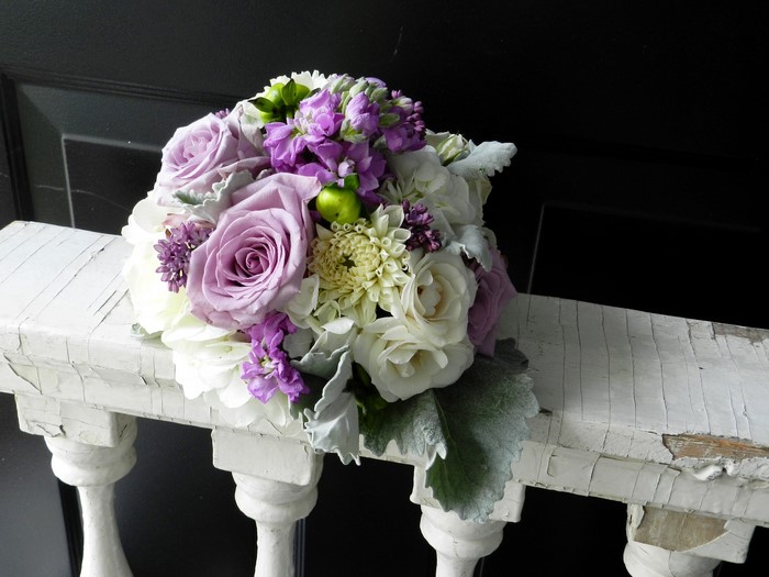 Purple and white flower bouquet on railing