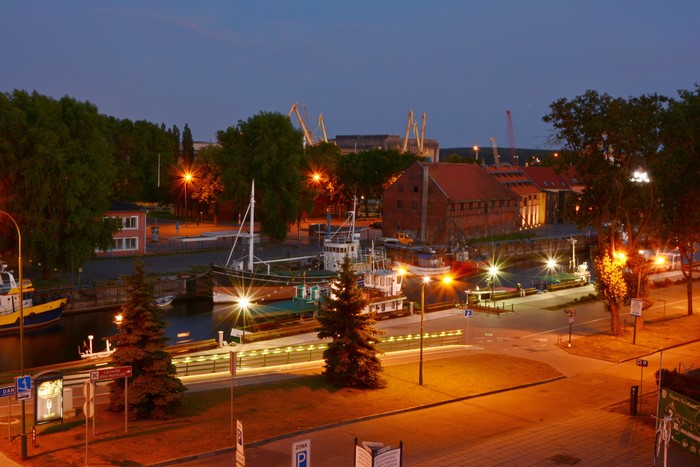 Klaipeda Lithuania harbor at night with boats and cranes