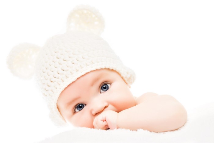 Baby wearing a white knitted hat with ears