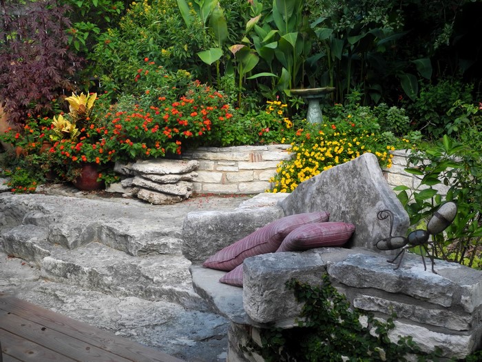 Stone garden seating with flowers and plants