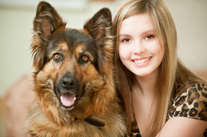 Blonde girl and German Shepherd dog
