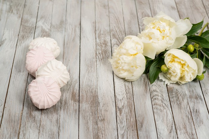 White Peonies and Pink and White Marshmallows on Wood