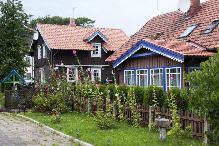 Houses with Malva flowers and fence in Nida, Lithuania
