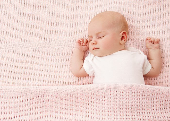 Baby sleeping on a pink blanket
