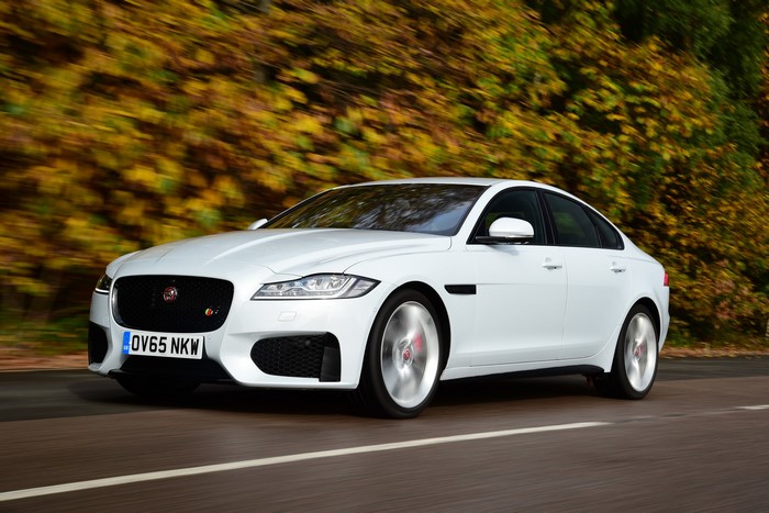 White Jaguar XF S driving on a road