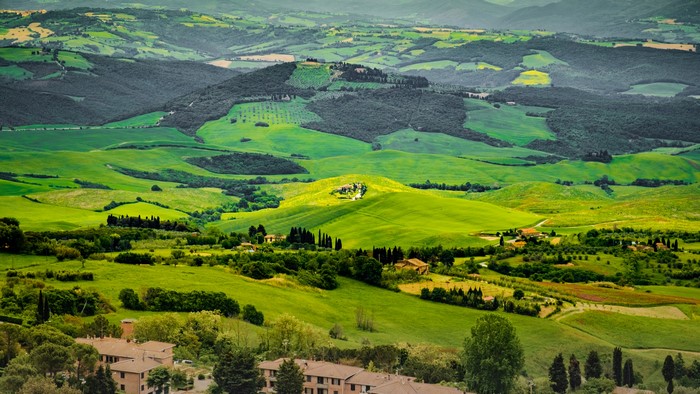 Tuscan landscape with rolling green hills and houses