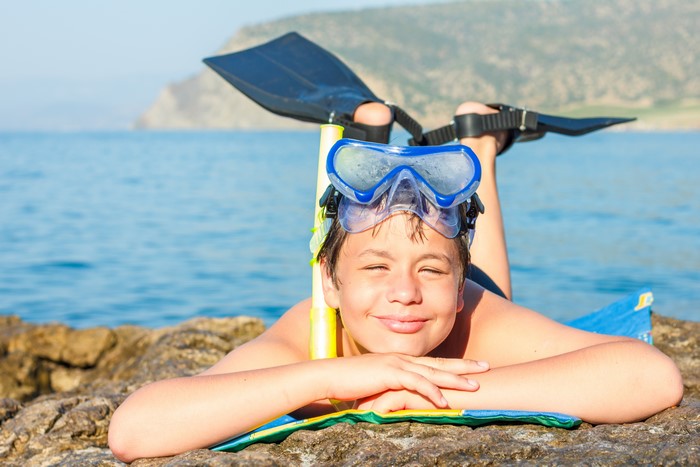 Boy with Snorkel Gear on Beach