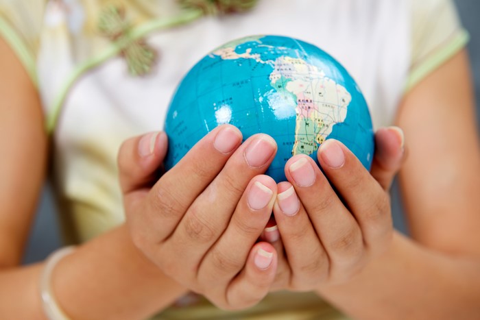Hands holding a globe