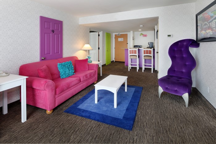 Living room with pink sofa and purple chair