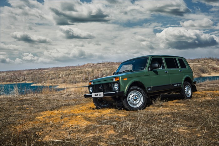 Green Lada 4x4 (2131) SUV parked by a lake