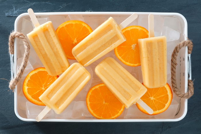 Orange popsicles with orange slices on ice