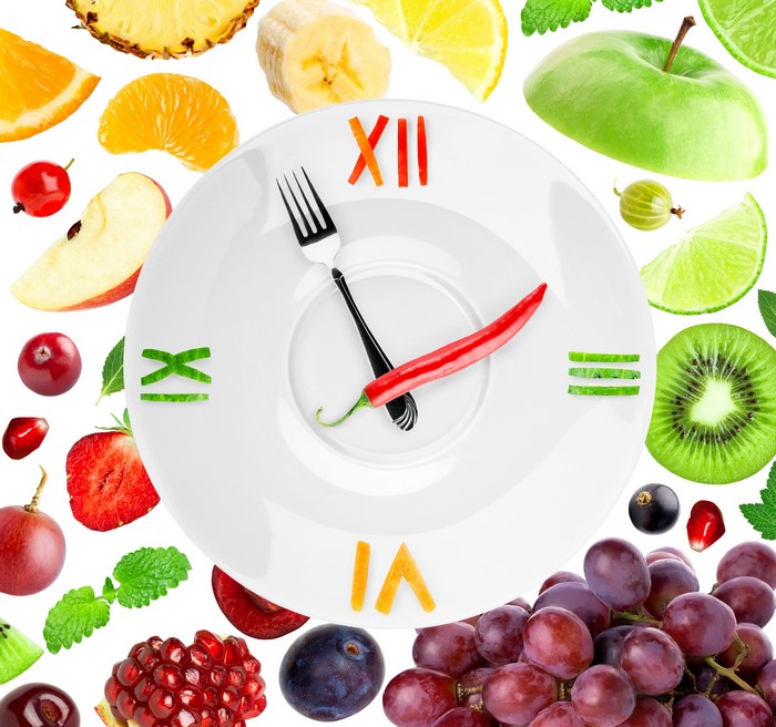 Fruit clock with fork and chili pepper