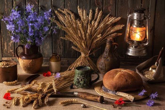 Still-life with bread, wheat, and kerosene lamp
