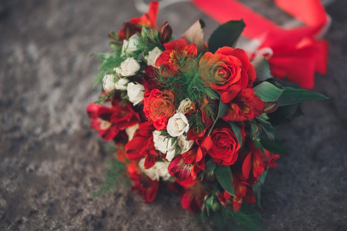 Red and white rose and alstroemeria bouquet with red ribbon