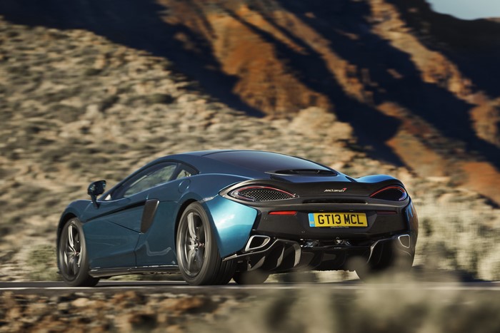 McLaren 570GT driving on a road