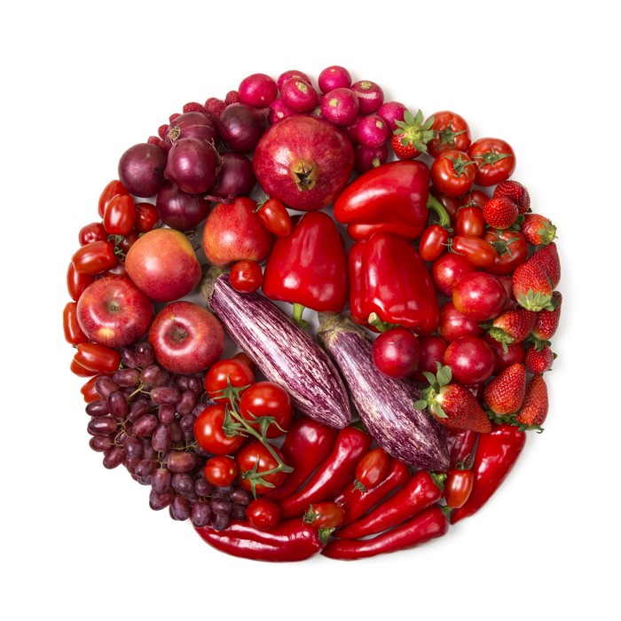 Assortment of Red Fruits and Vegetables on White Background
