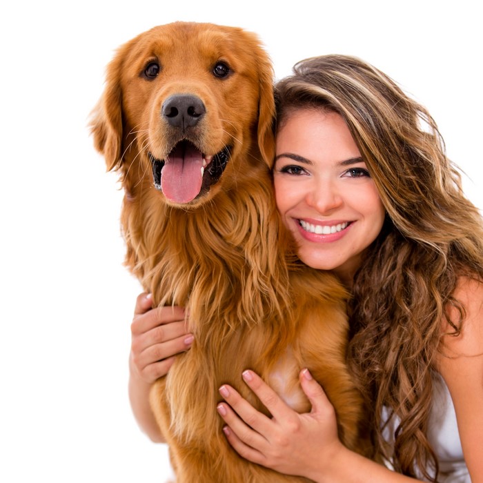 Woman hugging a golden retriever dog
