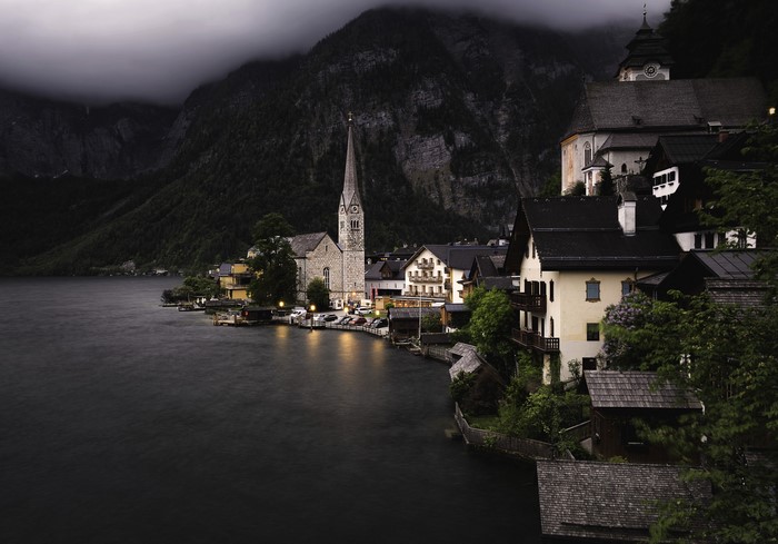 Hallstatt village on a lake at dusk with mountains
