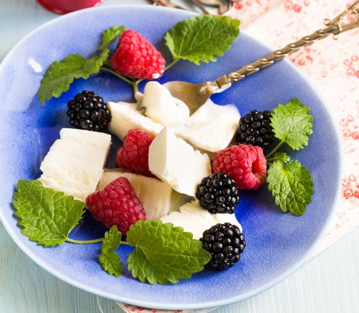 Plate of cheese with raspberries and blackberries