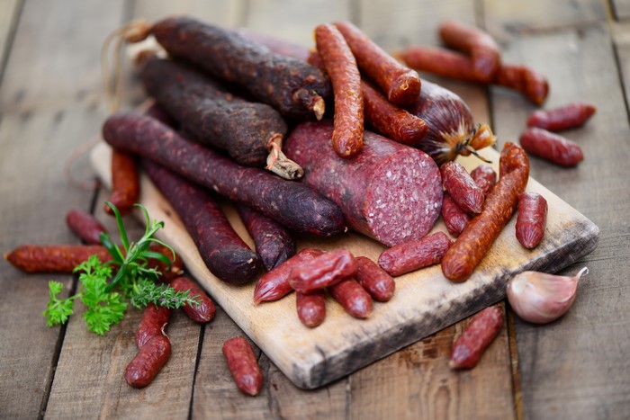 Assortment of sausages on a wooden board