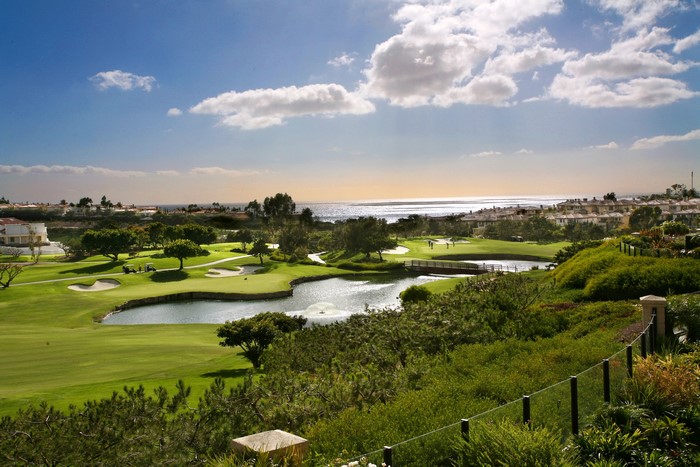 Golf course with ocean view and houses
