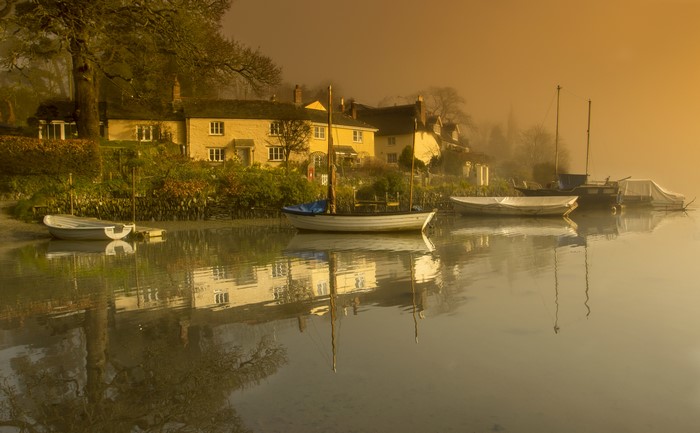 Houses and boats on a river in Cornwall, England