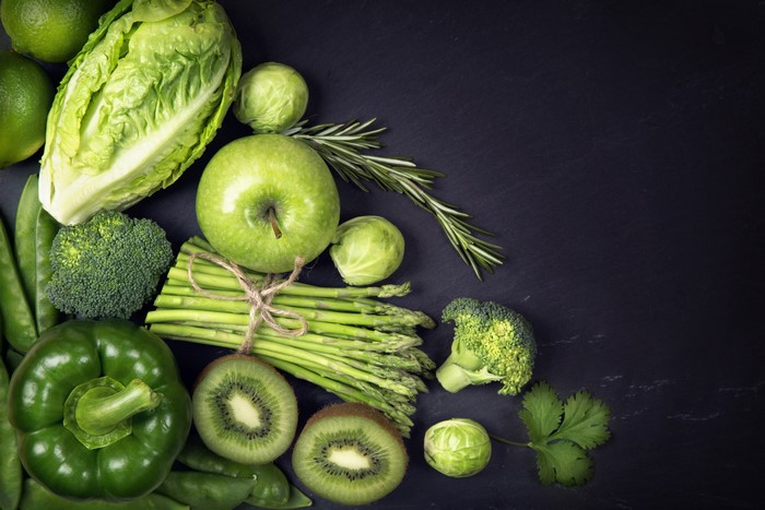Green fruits and vegetables on a dark background