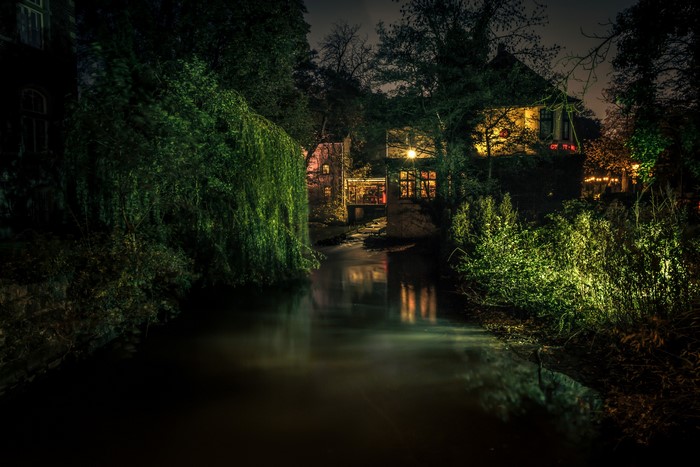 Houses by a river at night in Delmenhorst, Germany