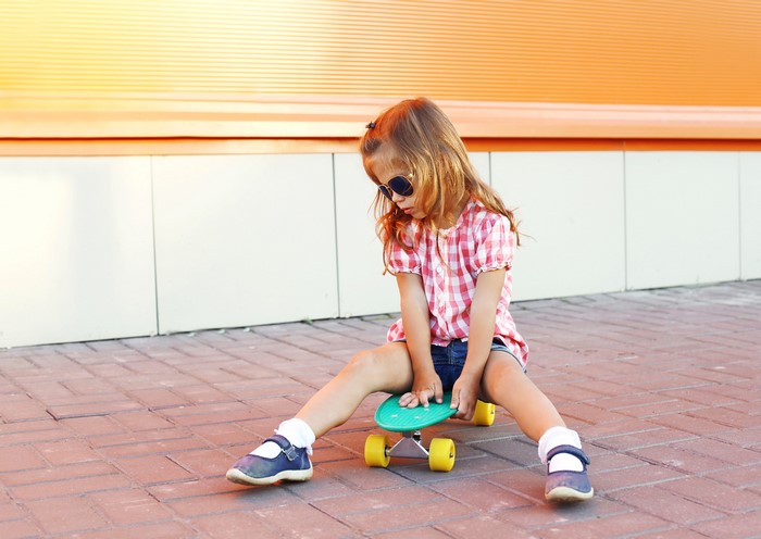 Girl with sunglasses on a skateboard