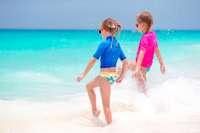 Two little girls in swimsuits at the sea