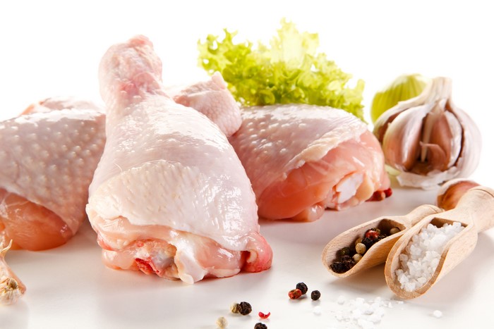 Raw chicken legs with spices and garlic