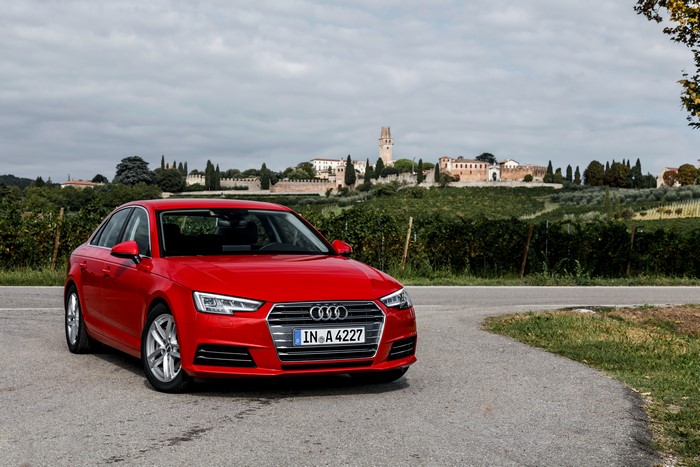 Red Audi A4 2.0 TDI ultra parked on a road