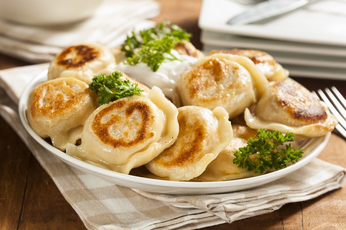Plate of Pierogi Varenyky with Sour Cream and Parsley