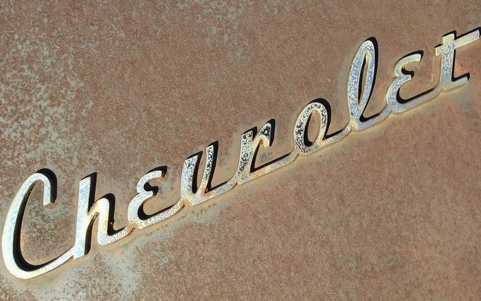 Chevrolet logo emblem on rusty surface