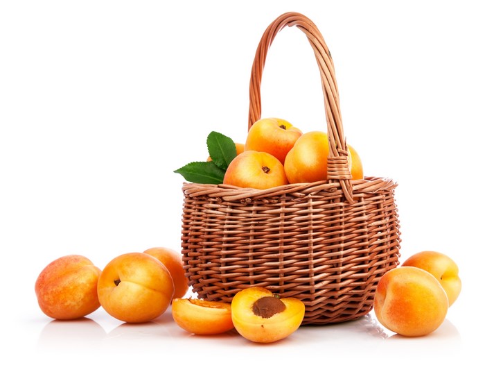 Apricots in a Wicker Basket on White Background