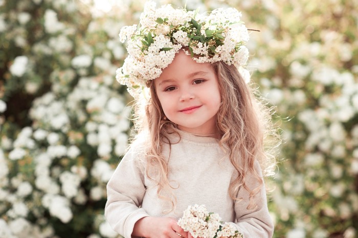 Little girl with blonde hair and flower crown