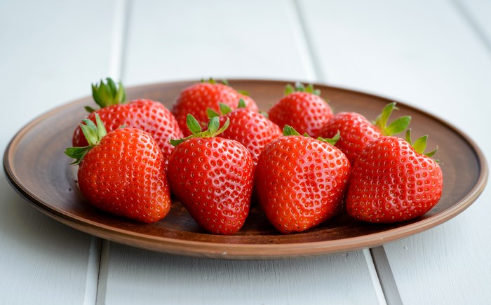 Strawberries on a brown plate
