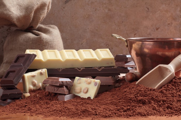 Chocolate bars and cocoa powder with copper pot
