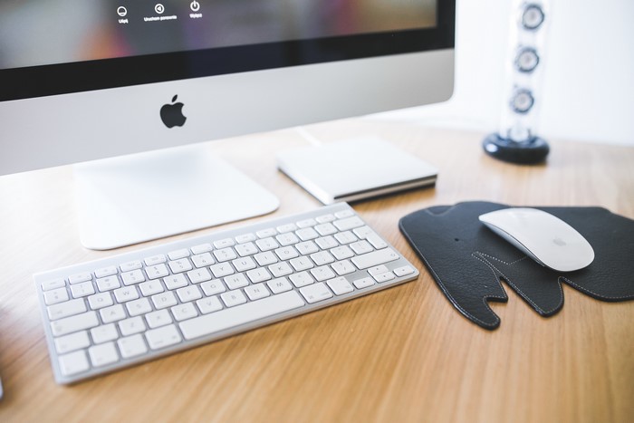 Apple iMac computer with keyboard and mouse on desk