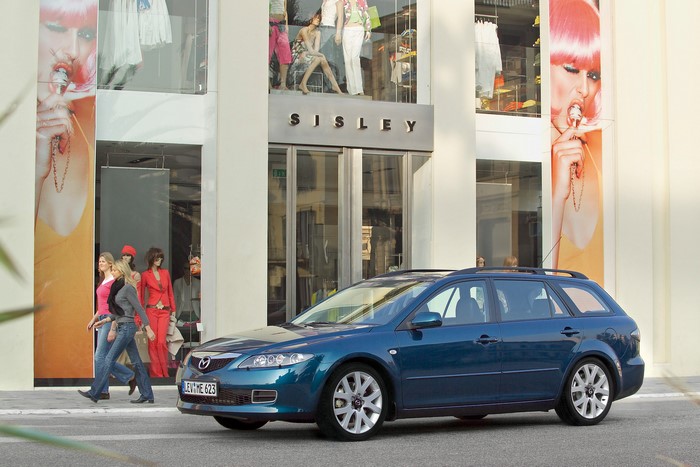 Blue Mazda 6 Wagon parked in front of Sisley store