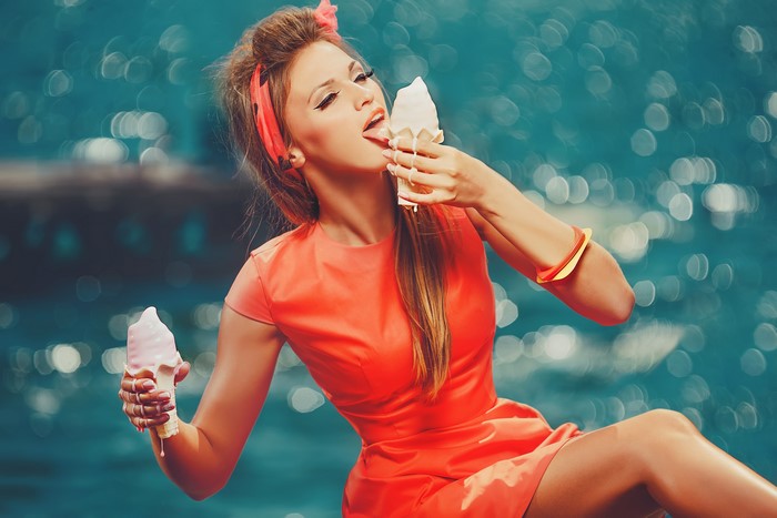 Woman in orange dress eating ice cream