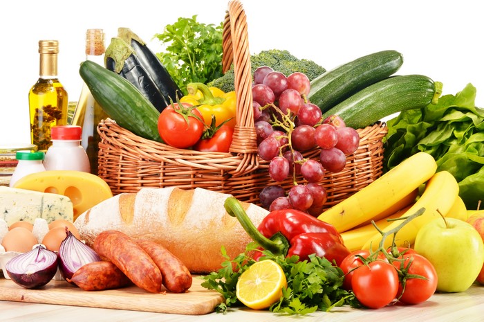 Sausage, Bread, Vegetables, Fruit, and Grapes in a Wicker Basket
