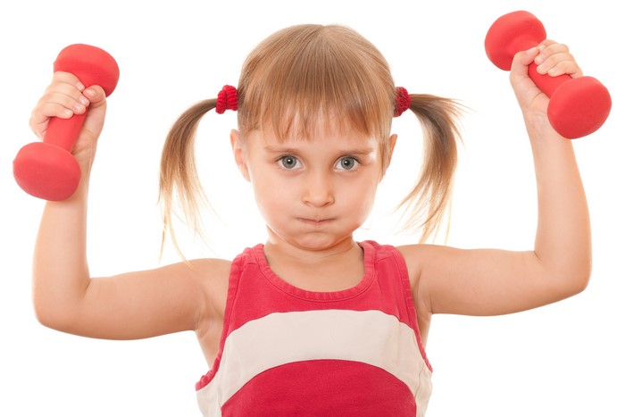 Little girl with dumbbells