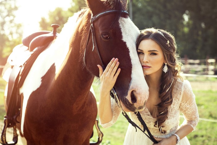 Woman in lace dress with horse